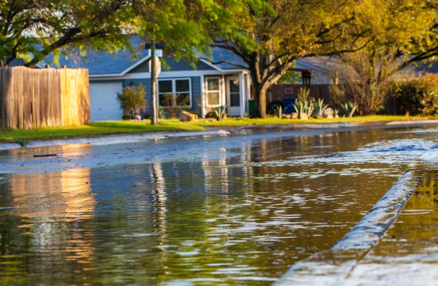 A flooded street in a residential neighborhood.