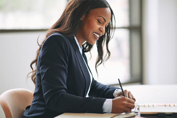 Female insurance agent writing a fidelity bond for a business insurance customer.