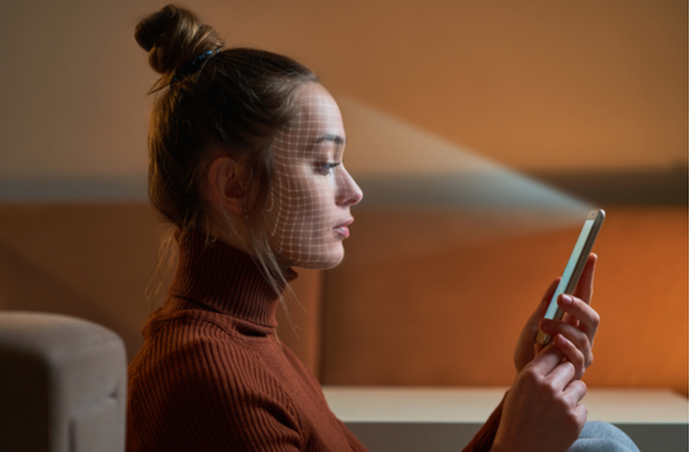 Image of a woman using face ID log in for her phone